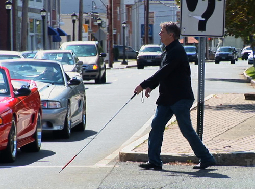 Blind man crossing the street.